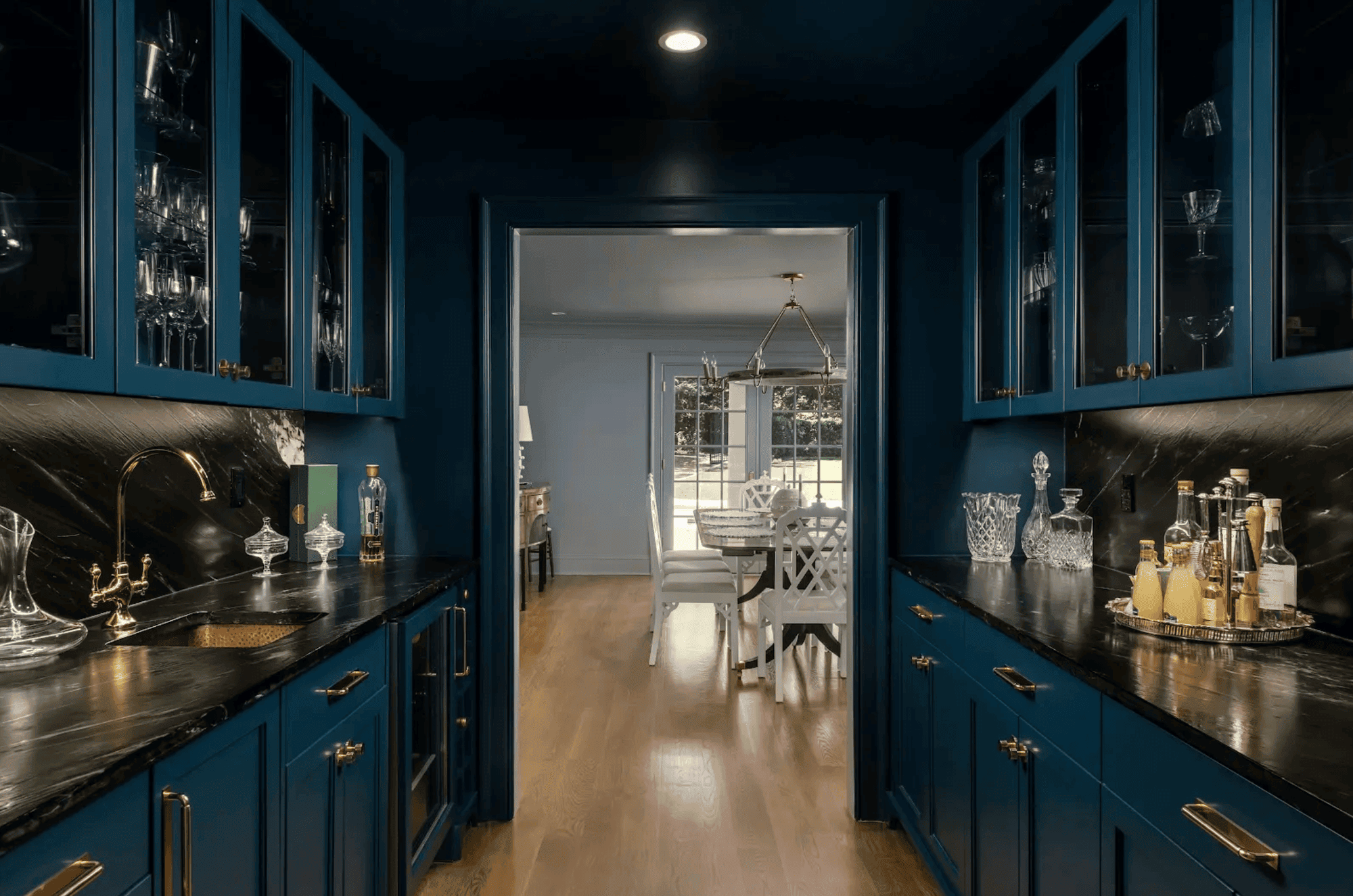 Elegant navy-blue bar area with glass-front cabinets